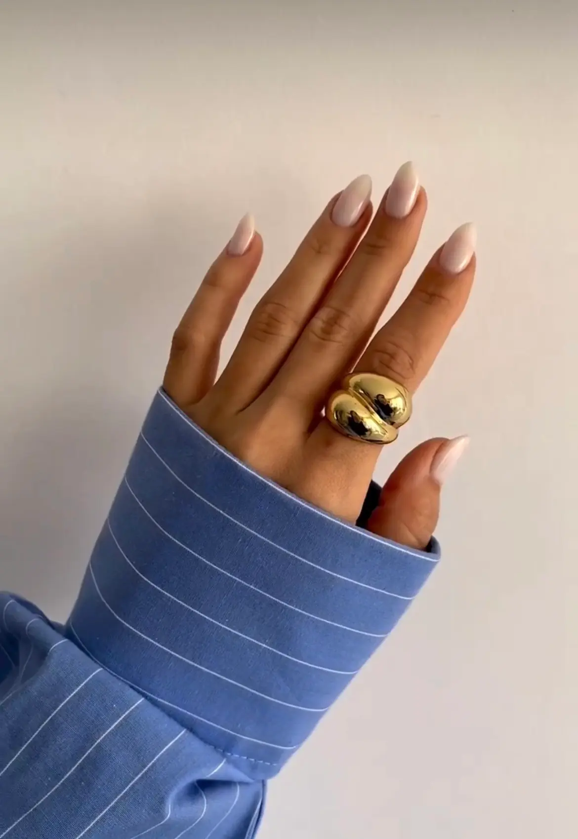 Milky white almond-shaped manicure by Nails by Algena in Sliema, Malta